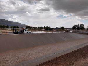 Flood waters in a ditch with an overcast sky