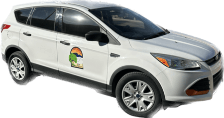 A small white SUV with the City of Alamogordo seal on the door.