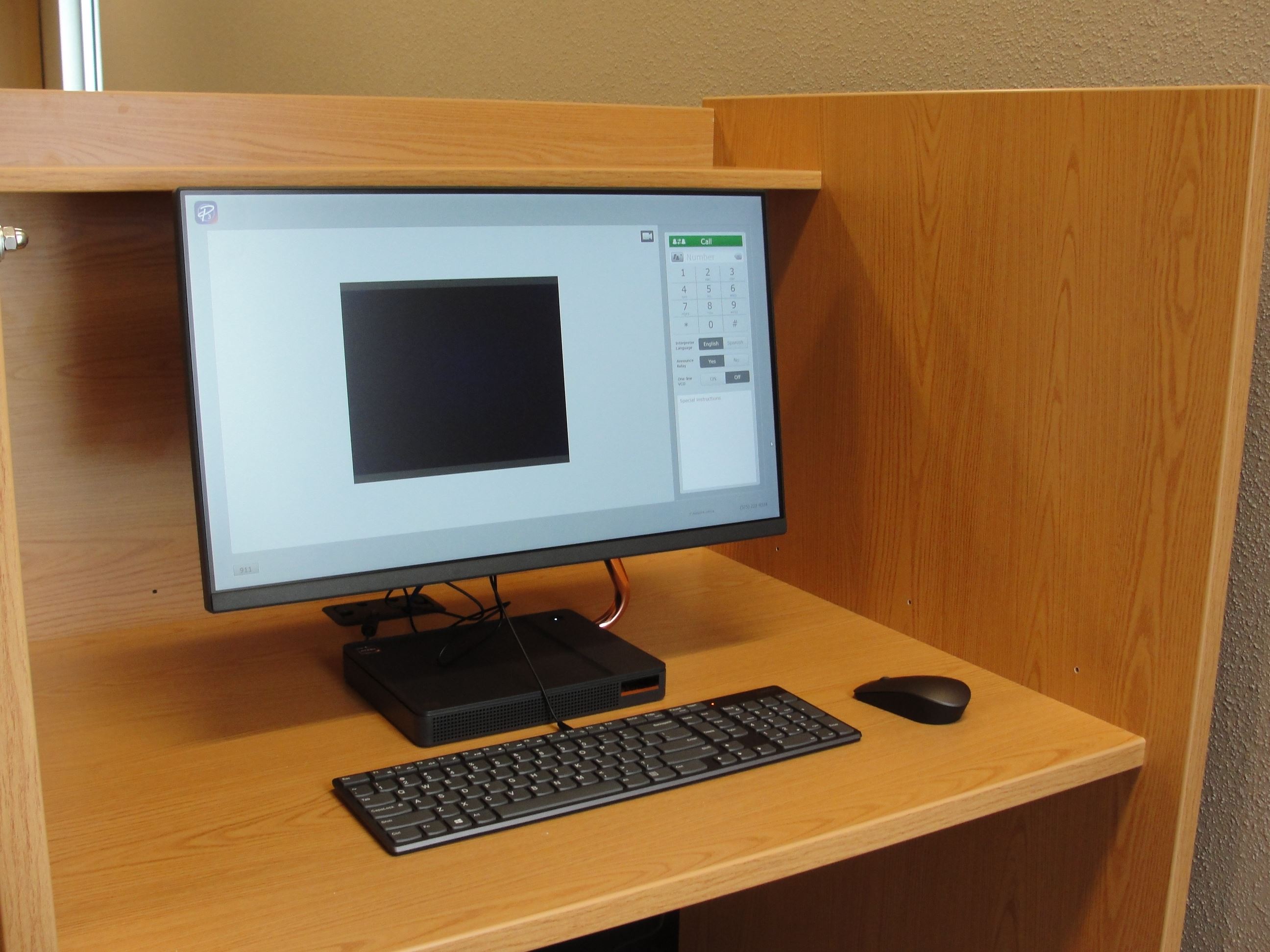 The Video Relay Service computer sitting on a desk at the library.